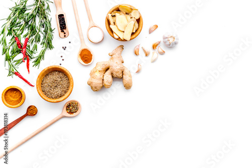 Seasoning background. Dry spices near ginger, garlic, rosemary, chili on white background top view copy space