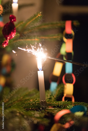 Christmas burning candle on a tree