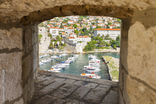Look through an abrazura in an old wall. Dubrovnik old city street. Croatia. Soft focus.