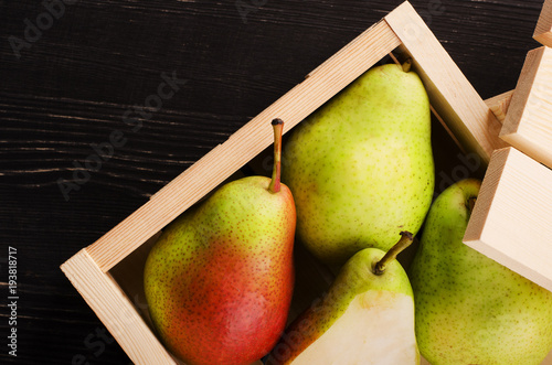 Green-red pears in wooden box