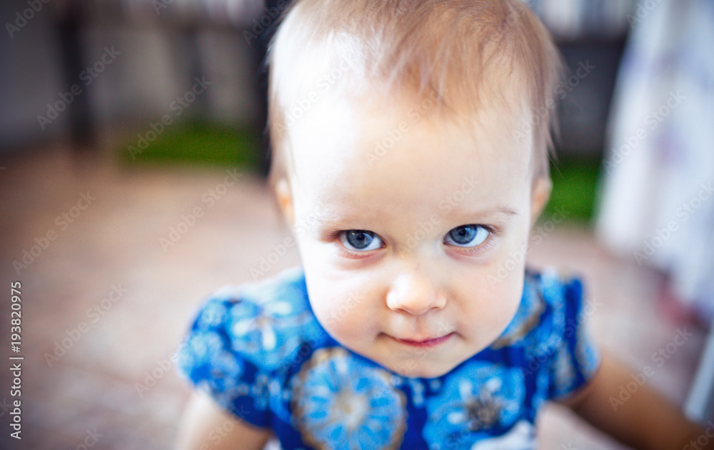 Year-old baby girl with blue eyes looking at camera. Happy little child Year-old baby girl with blue eyes looking at camera. Happy little child