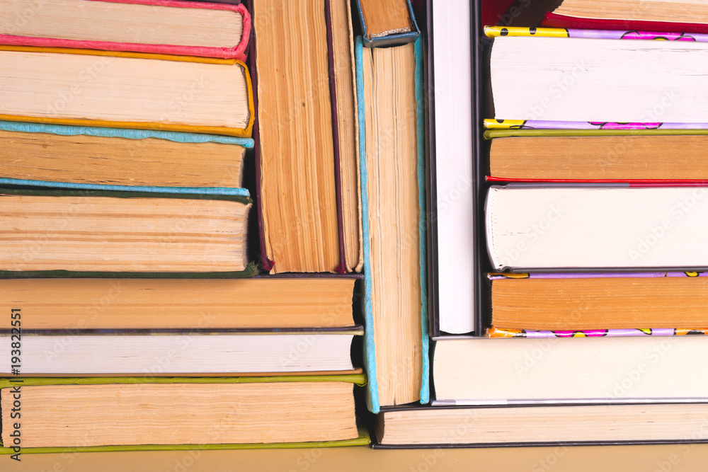 Fototapeta premium Open book, hardback books on bright colorful background.