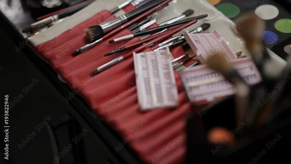 Luxurious make-up cosmetics. Professional cosmetics in the make-up salon. Luxurious cosmetics for make-up. Multicolored lipstick, shadows, powder, pencils close-up Luxurious make-up cosmetics. Professional cosmetics in the make-up salon. Luxurious cosmetics for make-up. Multicolored lipstick, shadows, powder, pencils close-up