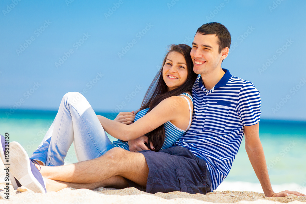 in love couple on the sea beach in summertime. in love couple on the sea beach in summertime.