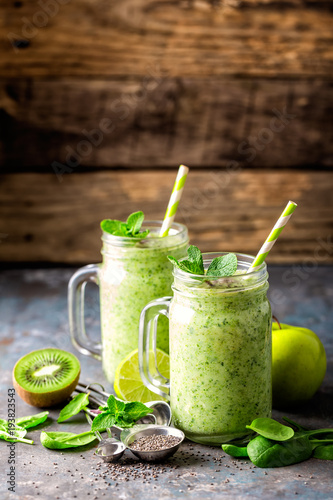 green smoothie with spinach, apple, kiwi, lime and chia seeds. healthy diet eating, superfood