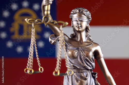 Symbol of law and justice with Georgia State Flag. Close up.