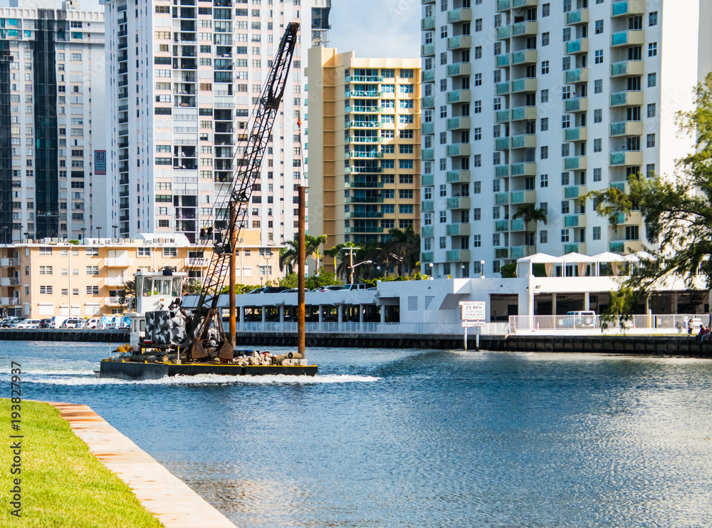 Fototapeta premium Barge with crane on waterway