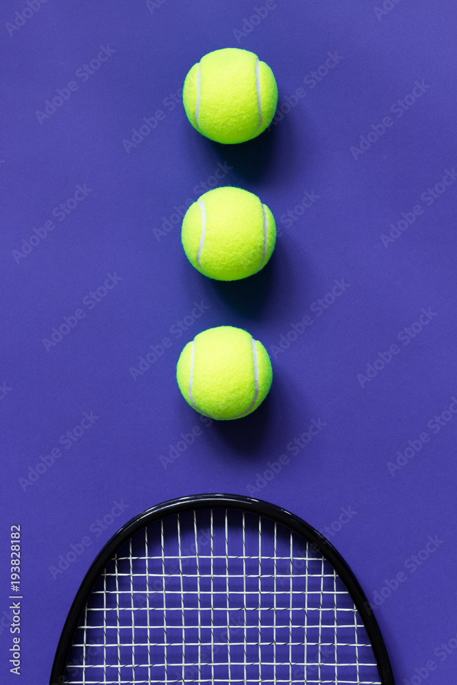Tennis balls and racket. Violet background. Concept sport.