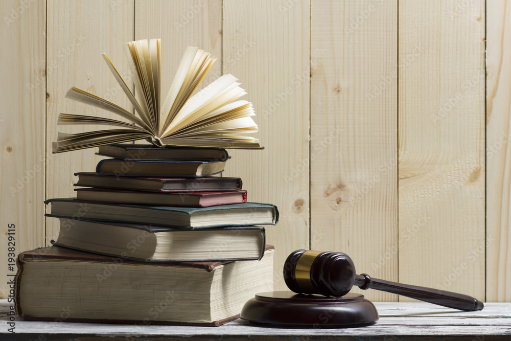 Legal Law concept - Open law book with a wooden judges gavel on table in a courtroom or law enforcement office. Copy space for text Legal Law concept - Open law book with a wooden judges gavel on table in a courtroom or law enforcement office. Copy space for text