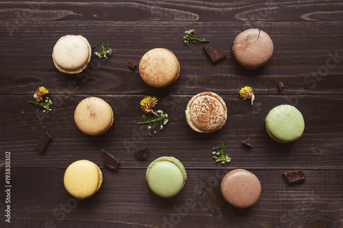 Sweet background. Delicious macaroons on the wooden table, top view