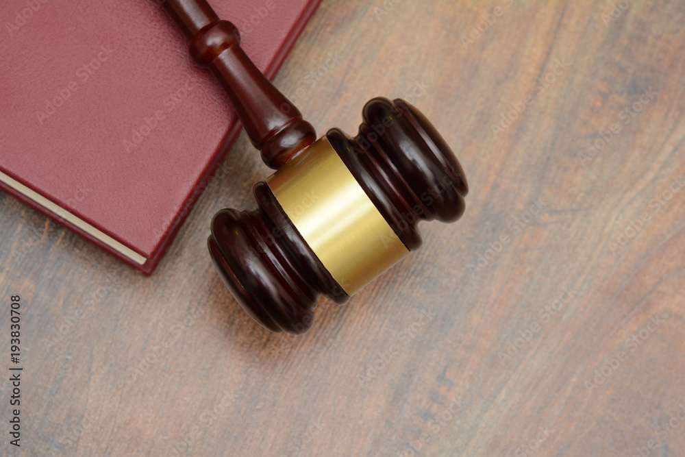 Top View Gavel and law book on courtroom table Top View Gavel and law book on courtroom table