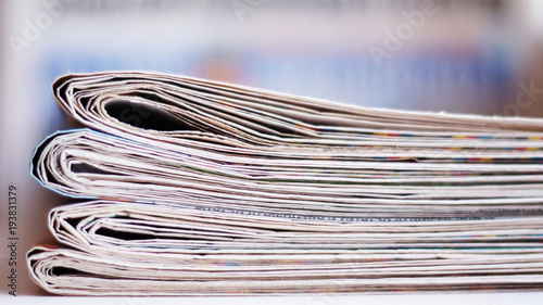 Newspapers folded and stacked in a pile, selective focus