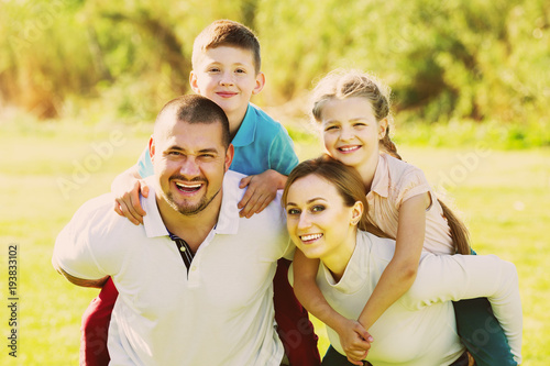 Parents holding kids on shoulders