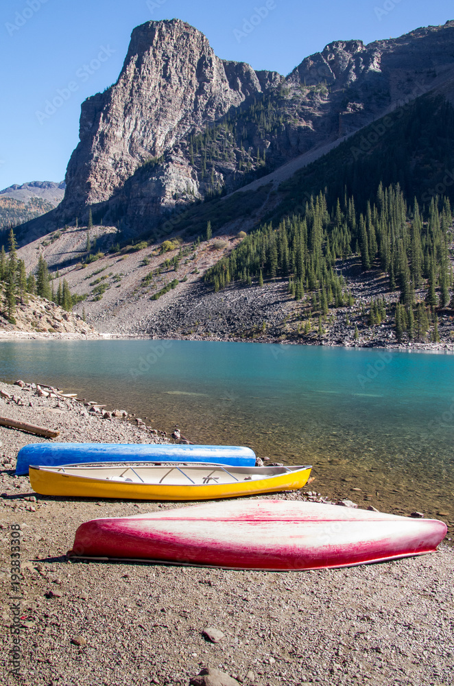 Canoes Waiting Alongside Mountain Lake Canoes Waiting Alongside Mountain Lake