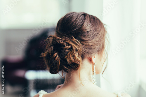 Beautiful young bride with wedding makeup and hairstyle. Happy Bride waiting groom. Bride portrait soft focus