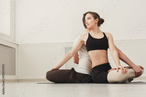 Young couple practicing yoga together in gym