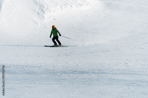 Skier on the ski slope skiing downhill