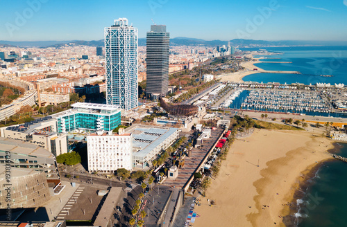 Aerial view of Barcelona with skyscrapers on coast