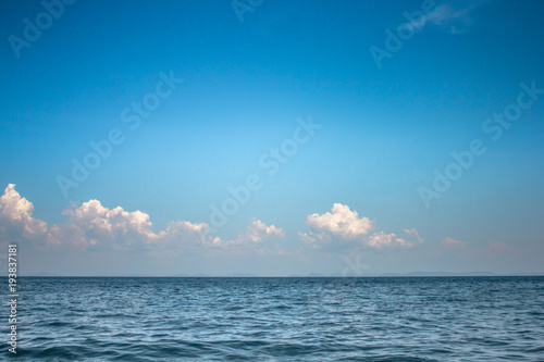 Cloud on the blue sky over calm sea.