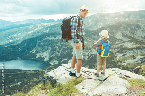 Father and son traveling in Rila mountains Bulgaria