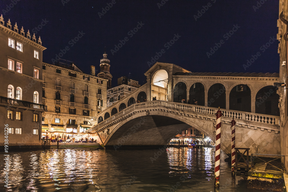 Night view of the Canal Grande with illuminated houses and Rialto Bridge, Venice, Italy