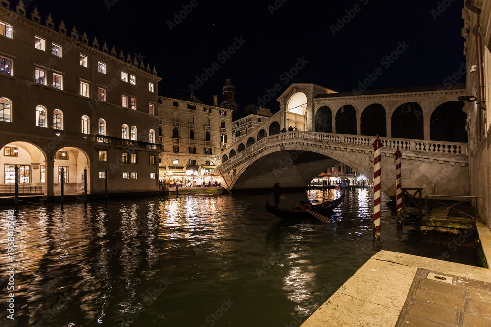 Night view of the Canal Grande with illuminated houses and Rialto Bridge, Venice, Italy