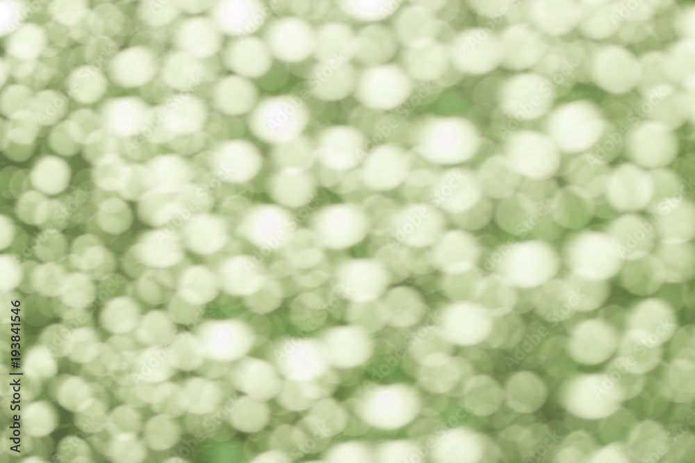 Obraz premium Abstract green blurred bokeh background from water drops