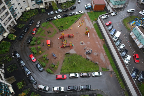 Parked cars in the courtyard of a block of flats in a new district of St. Petersburg. view from above