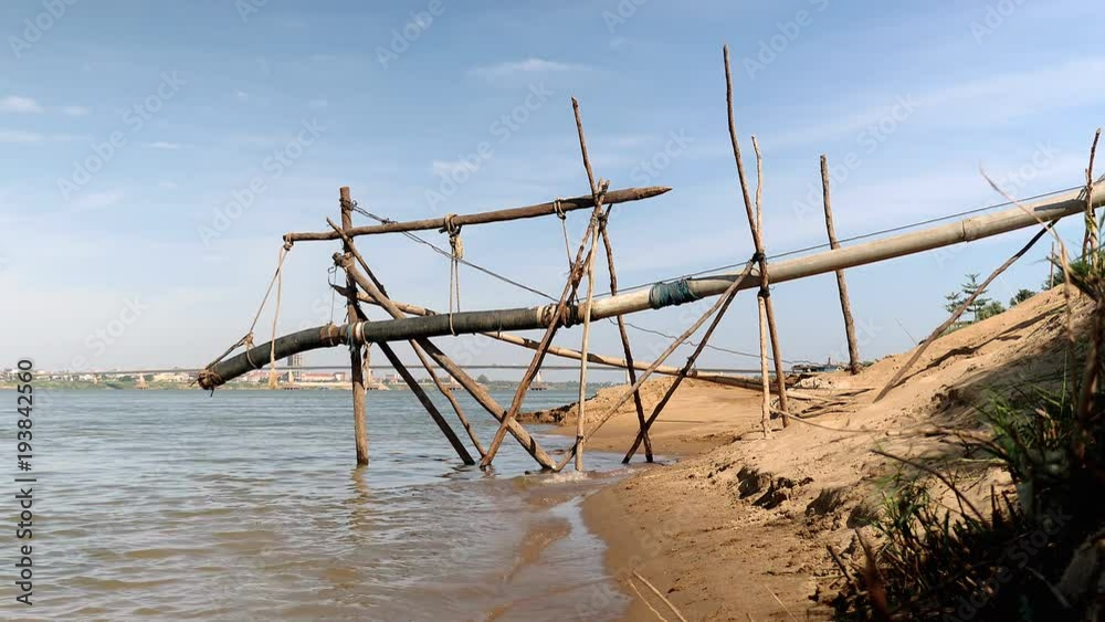 Piping system going down river and hold with bamboo structure Piping system going down river and hold with bamboo structure