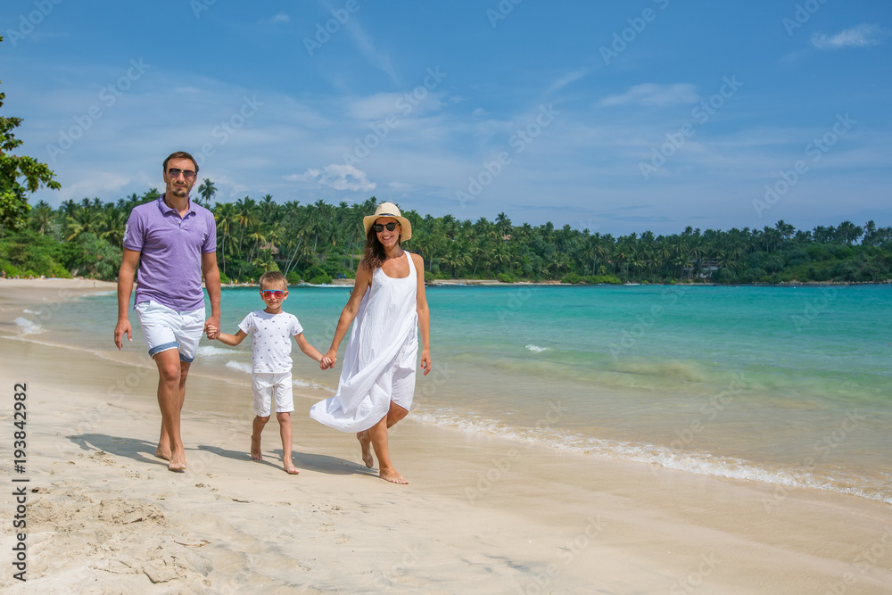 Family on vacation at the seashore of Indian ocean