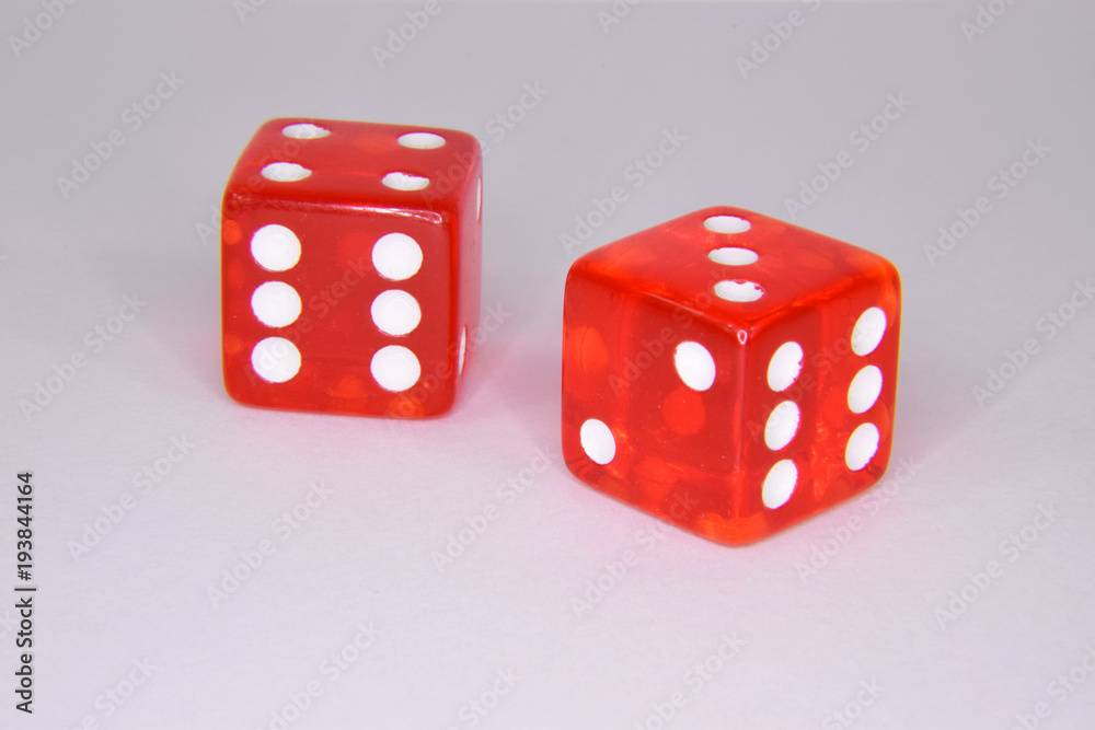 Thrown Red Casino Gambling Dice - Showing Numbers Three and Four Thrown Red Casino Gambling Dice - Showing Numbers Three and Four