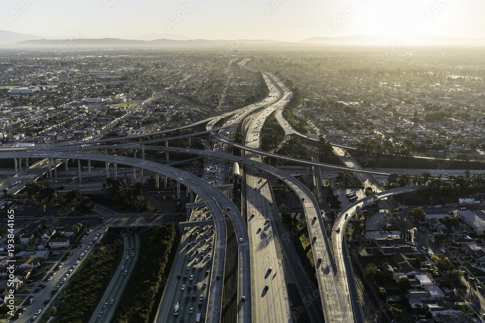 Aerial sunrise view of 105 and 110 freeway interchange ramps in Los Angeles California.