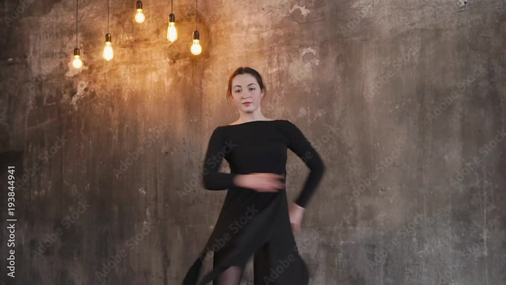 a young and handsome dancer performs body twists during a dance, a woman trains her performance for a concert at a modern dance school a young and handsome dancer performs body twists during a dance, a woman trains her performance for a concert at a modern dance school