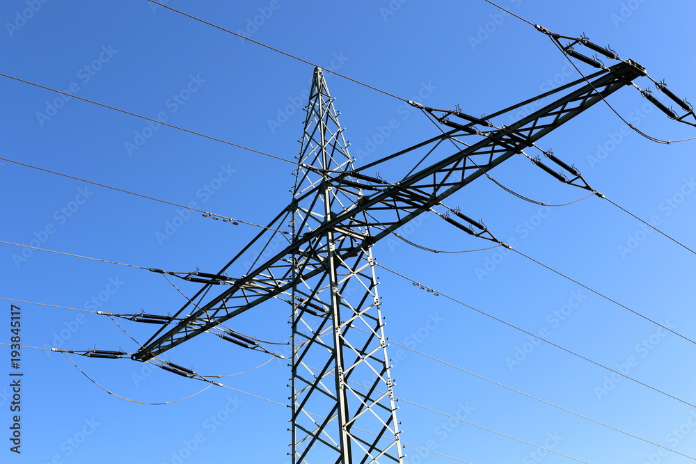 High voltage tower in front of blue sky
