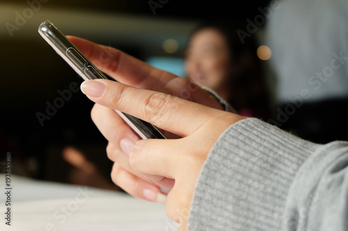 Woman's hand holding smartphone.