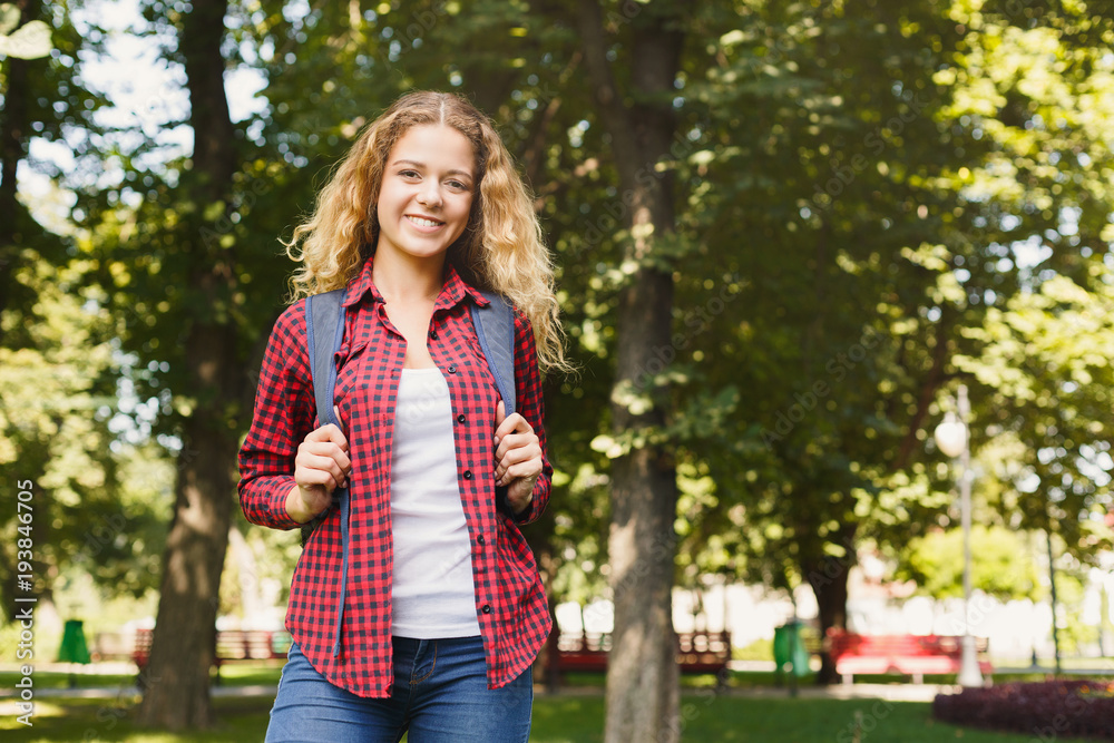 Happy female student standing in the park Happy female student standing in the park