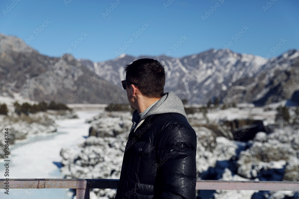 men with sunglasses looking back to mountains