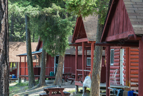 Row of Log Cabins at a Primitive Rustic Resort  in a Forest