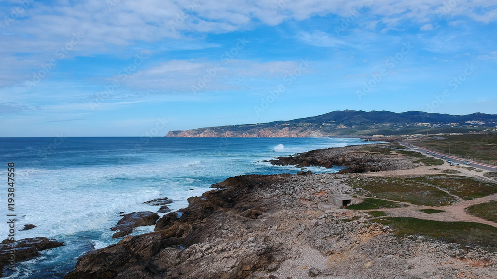 Aerial view from the Portuguese coastline with the ocean and a mountain in background. Cascais Portugal