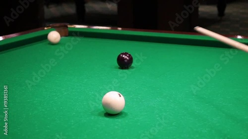 Billiards. Close-up of someone aiming the billiard ball with cue. Billiards game photo