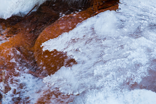 Red rock waterfall and  ice at Latvia. Travel photo. 2018 photo