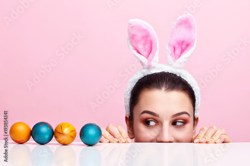 Canvas Print Happy young woman wearing bunny ears and having Easter Eggs