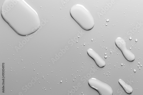 Surface with water drops, grey background.