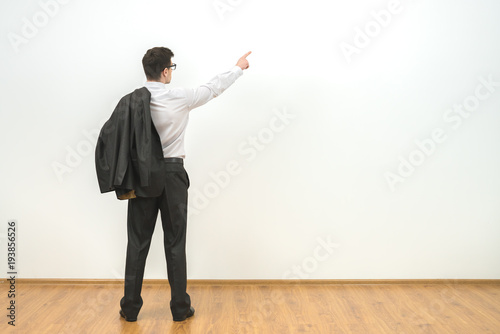 The man gesturing on the background of the white wall background