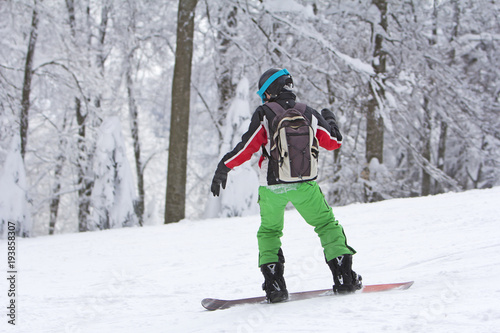 Winter sport snowboarder at ski slopeand alps mountains landscape