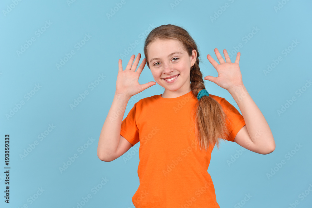 Happy girl on a blue background. Portrait of a teenager. Happy girl on a blue background. Portrait of a teenager.