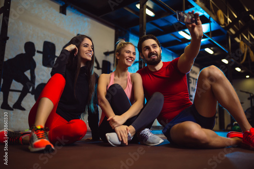 Friends having fun at the gym. Making a selfie photo.