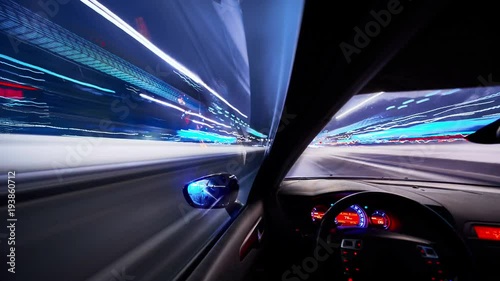 Timelapse video View from Side of Car moving in a winter night city, Blured road with lights with car on high speed. Concept rapid rhythm of a modern city.