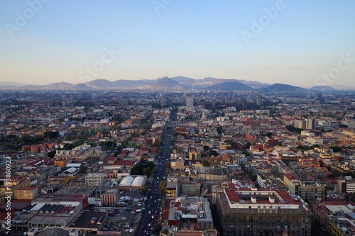 Aerial Mexico City view with mountain range in the background - clear sky