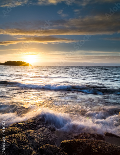 powerful waves against rocks at sunset